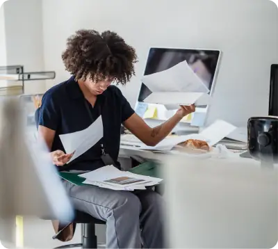 Stressed manager reviewing paperwork at a desk